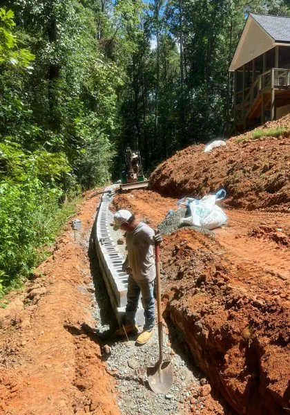 Retaining wall installation in progress by Verdescapes Solutions on a sloped Georgia property